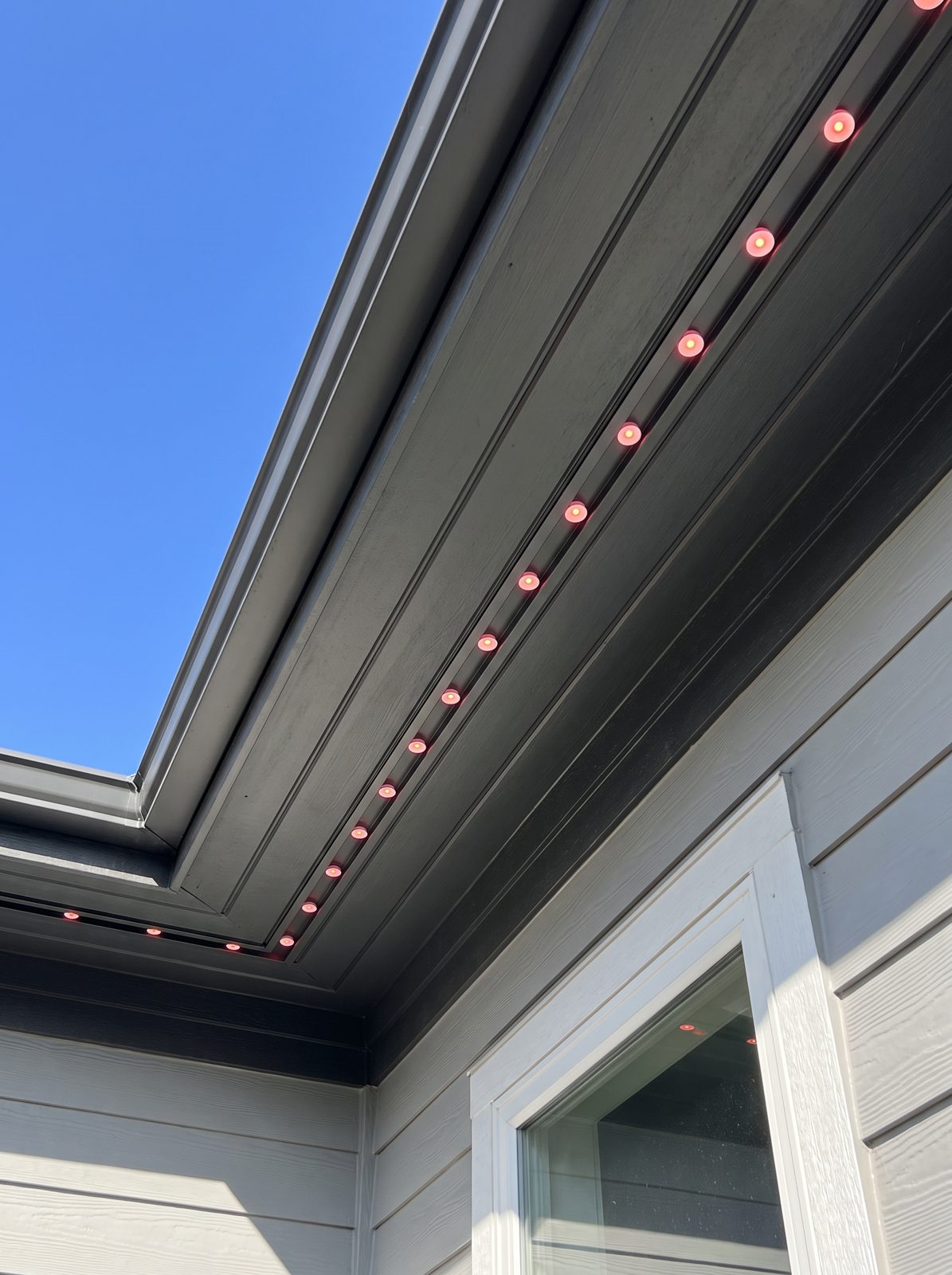 Daytime roofline with charcoal aluminum lighting track matched closely to the fascia